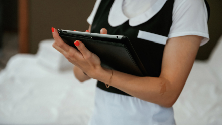Hotel housekeeper on tablet connected to dedicated WiFi network